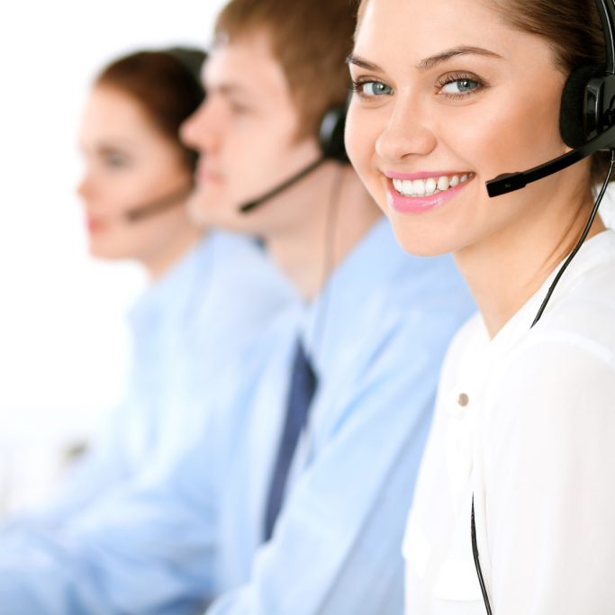 Call center operators. Focus at business woman in headset Call center operators. Focus at brunette business woman in headset